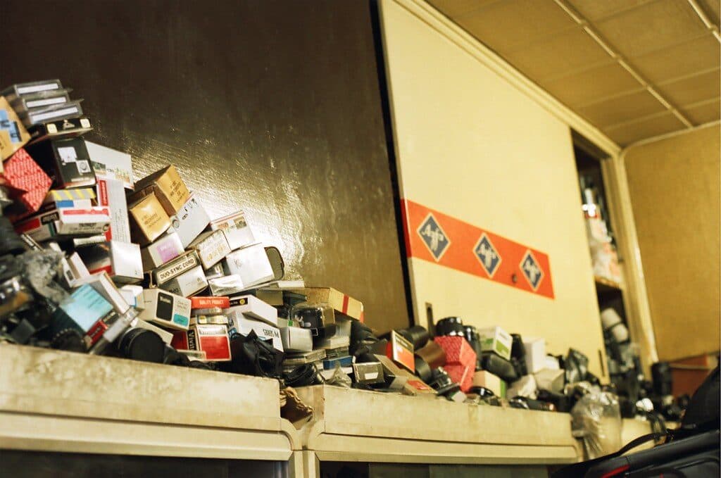 Boxes and household items piled to the ceiling in a hoarded room