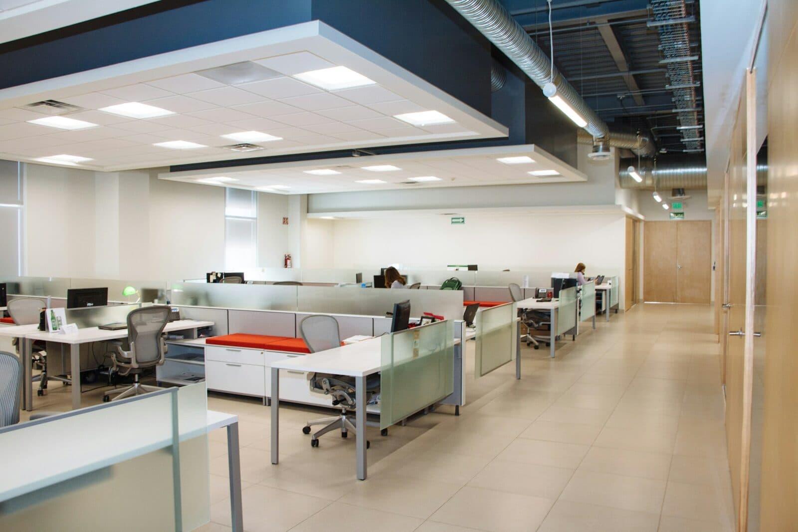 An open-plan office with rows of desks and chairs