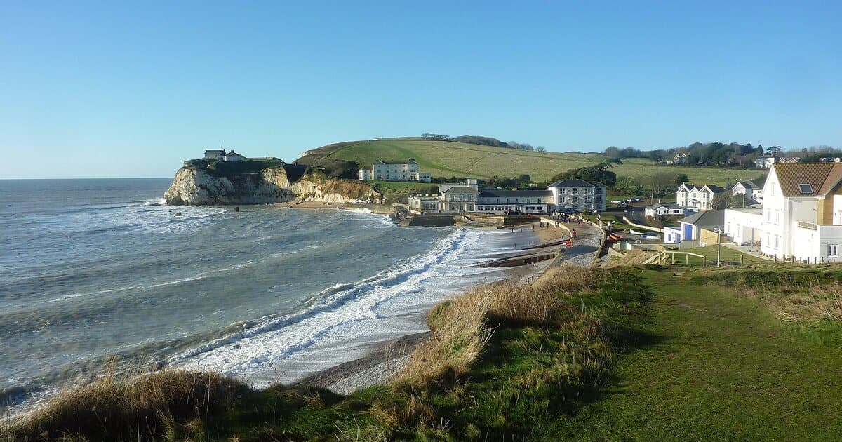 Freshwater Bay and the chalk cliffs from the clifftop on a sunny day