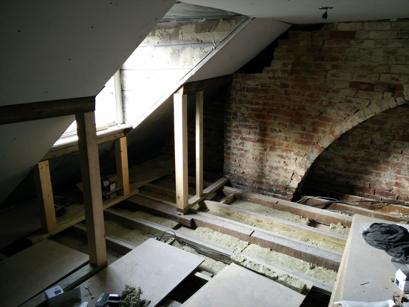An attic stripped back to the joists and brickwork