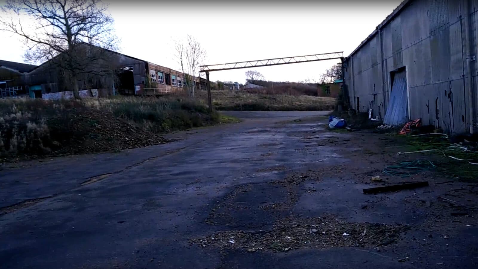 An industrial yard with old sheds and a gantry